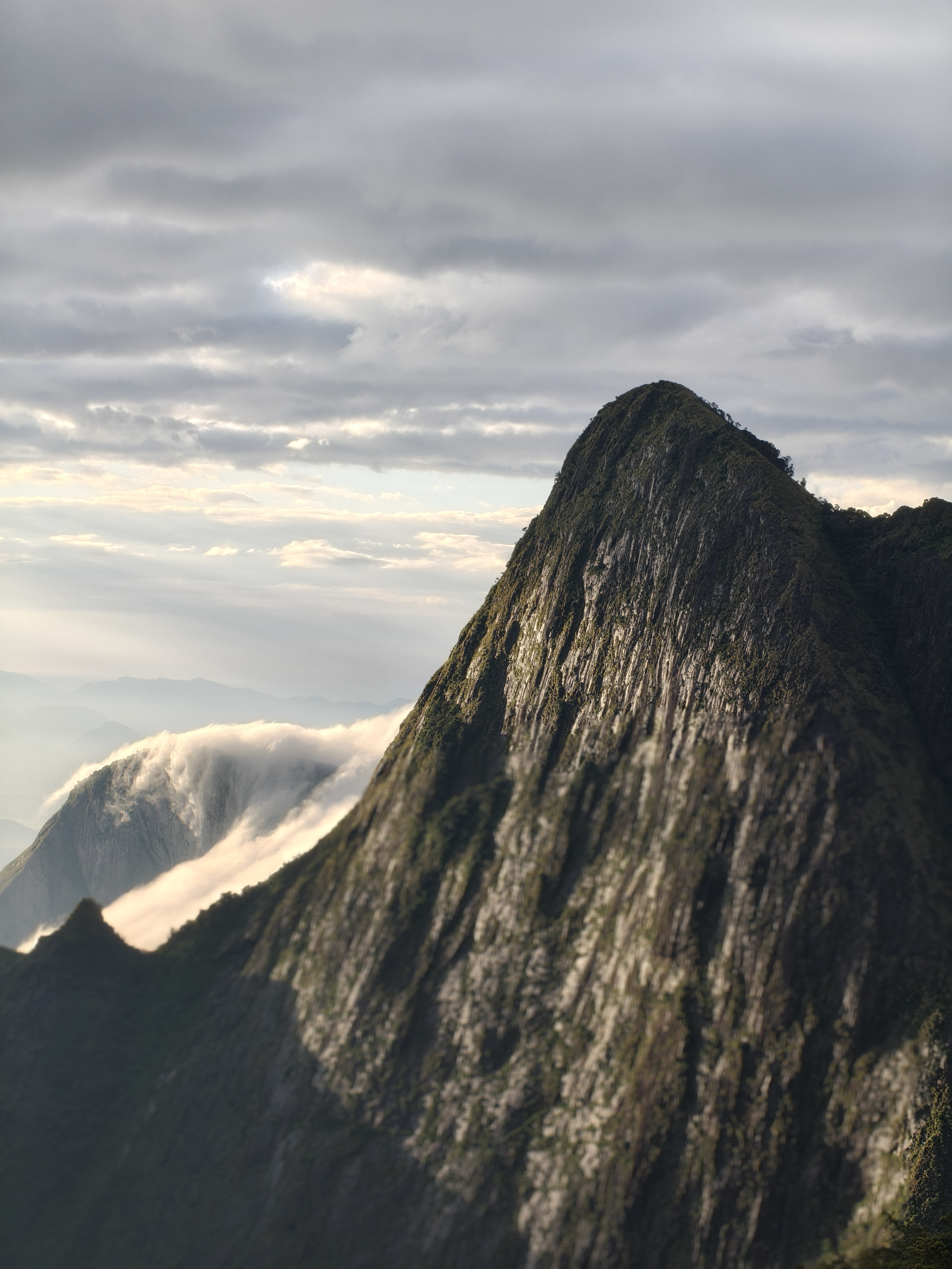 Kolukkumalai golden sun rays breaking through clouds over Western Ghats valleys